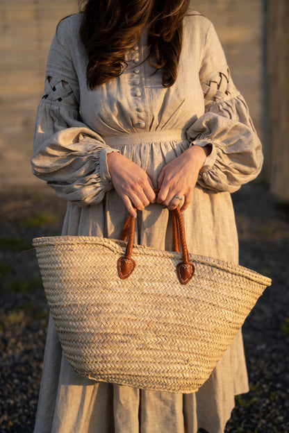 Meg March linen dress with puffy sleeves, with straw bag