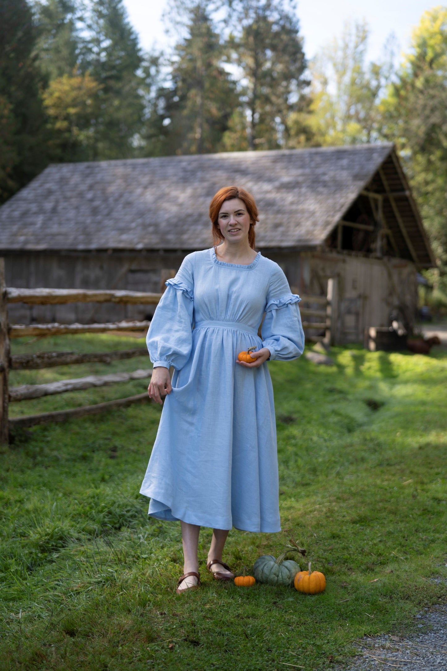 Ella Linen Dress in sky blue. 
- Fabric: 100% medium weight linen (190 g), Oeko-Tex Standard 100 certified
- Ruffled neckline
- Puffed sleeves
- Flared skirt
- Rear zip fastening
- Lacing on the back
- 2 side seam pockets
- Midi length