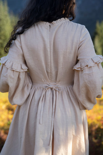 Ella linen dress in Beige colour with long sleeves
- Fabric: 100% medium weight linen (190 g), Oeko-Tex Standard 100 certified
- Ruffled neckline
- Puffed sleeves
- Flared skirt
- Rear zip fastening
- Lacing on the back
- 2 side seam pockets
- Midi length